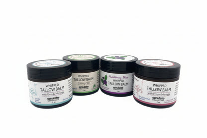 Four containers of tallow balm on a white background
