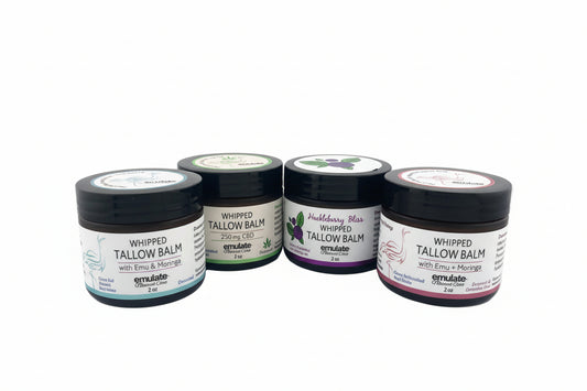 Four containers of tallow balm on a white background
