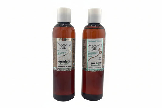 Two bottles of massage oil on a white background
